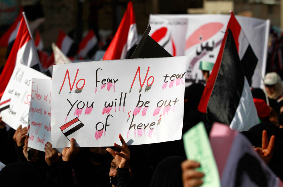 Девушки держат плакаты во время демонстрации