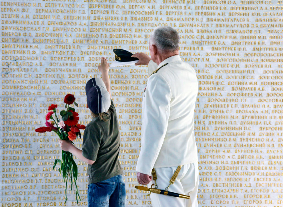 Ветеран ВОВ показывает своему внуку фамилию их семьи
