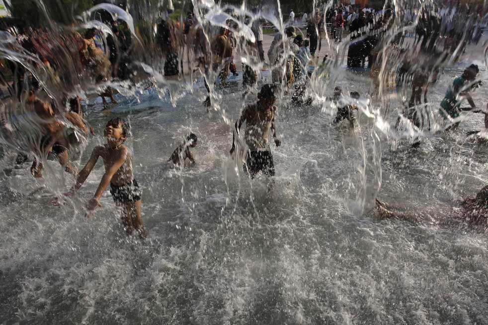 Дети купаются в фонтане 